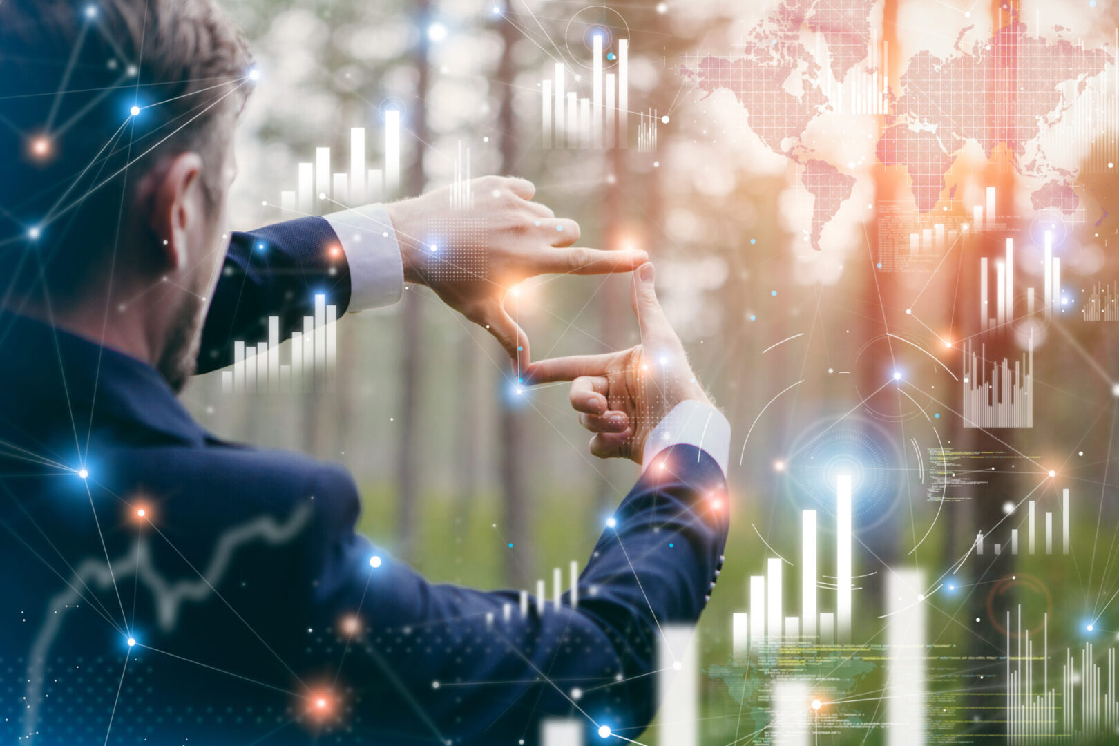 Businessman framing digital graphs with his hands, symbolizing strategy.