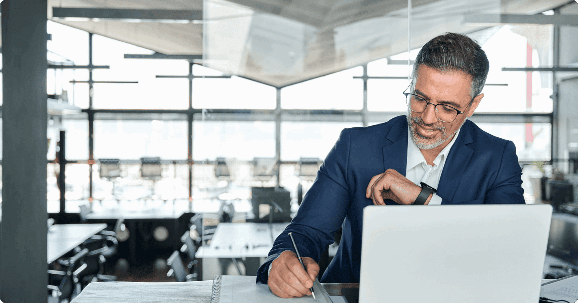 Man checking watch while writing notes