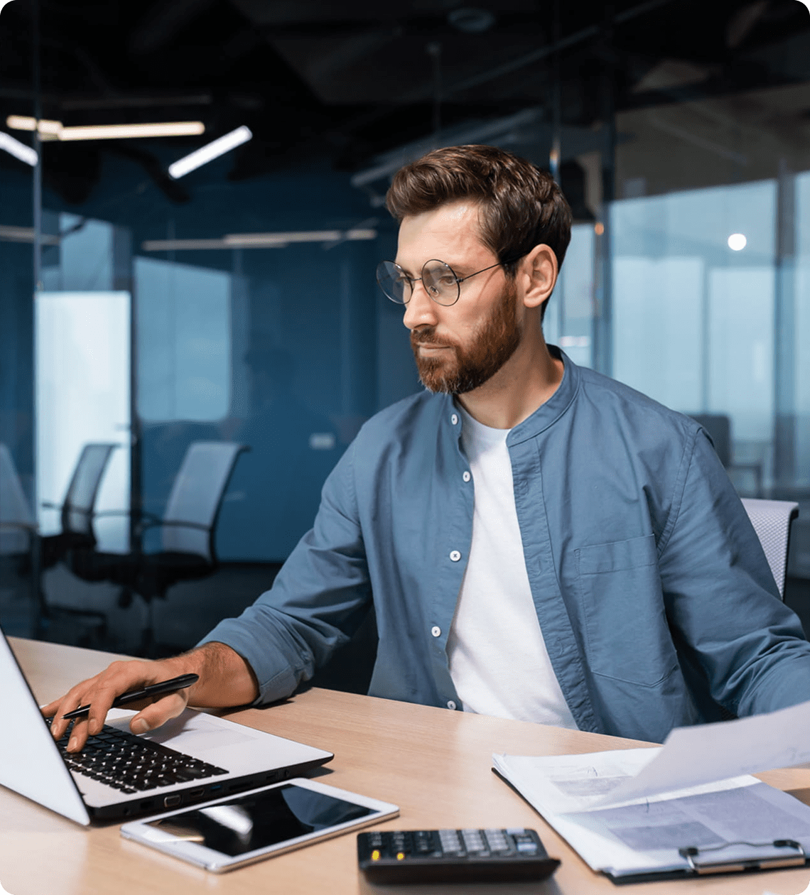Man working on laptop in modern office