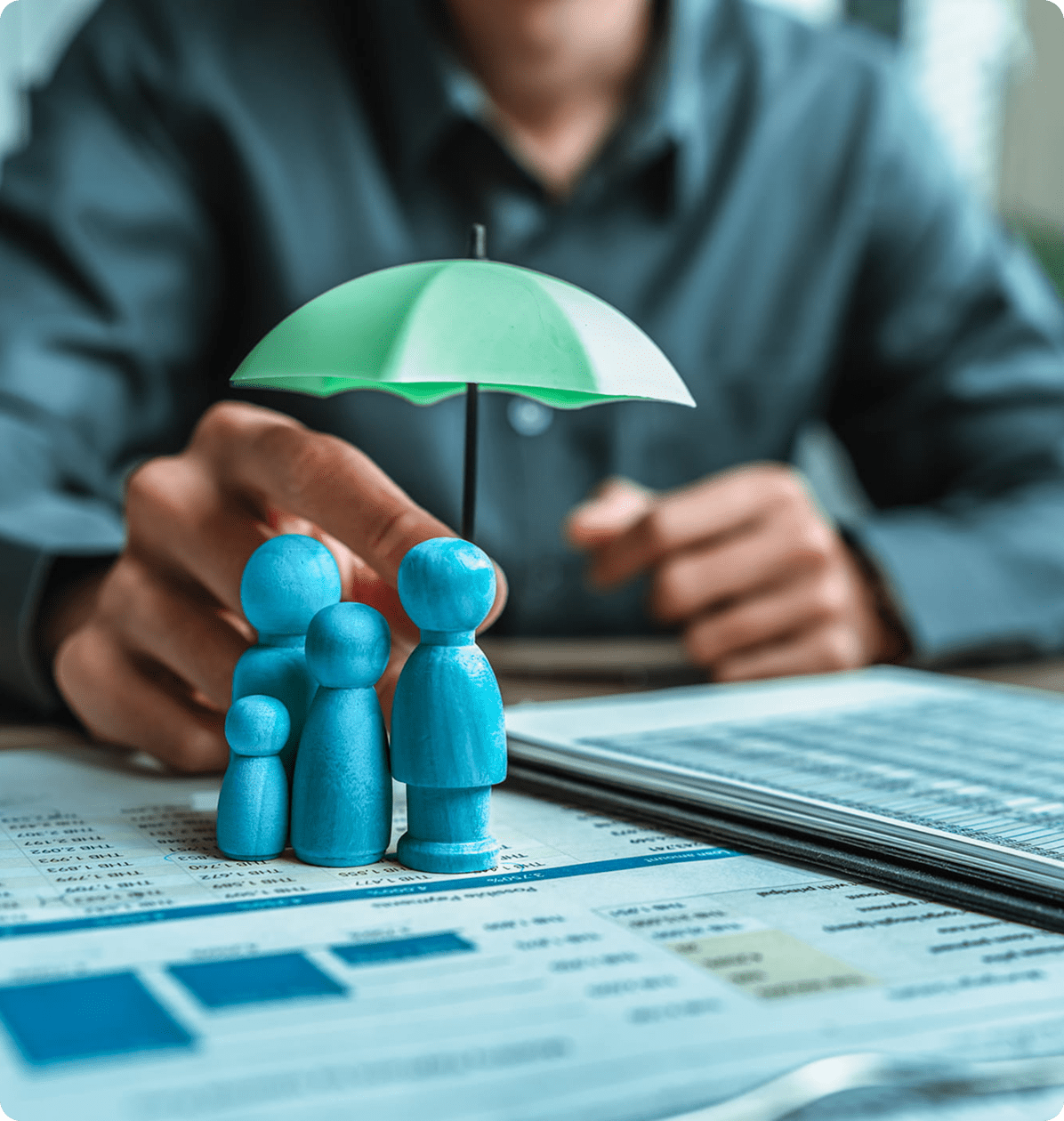 Family figurines under umbrella on documents