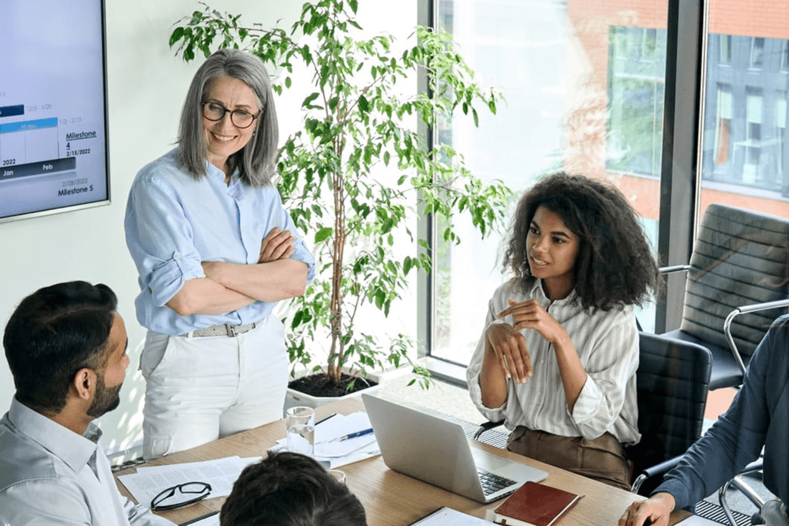 Two women engaged in a serious discussion during a meeting.